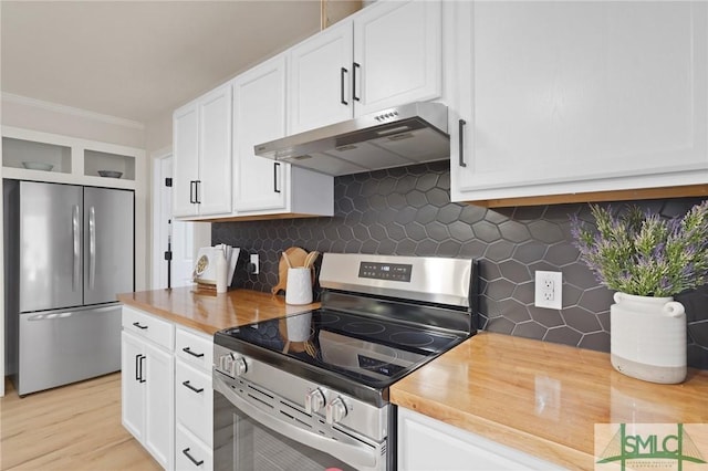 kitchen featuring backsplash, butcher block counters, range hood, and appliances with stainless steel finishes