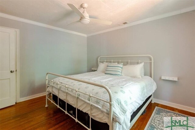 bedroom with baseboards, ornamental molding, wood finished floors, and a ceiling fan
