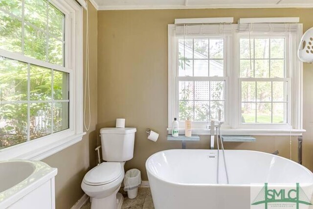 full bath featuring toilet and a soaking tub