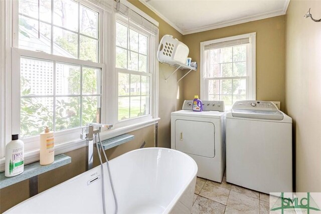 clothes washing area with independent washer and dryer, crown molding, laundry area, and a wealth of natural light