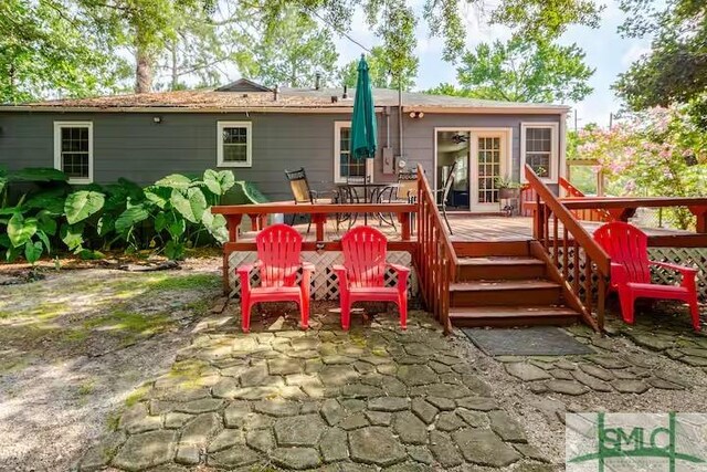 back of house featuring a deck and a patio area