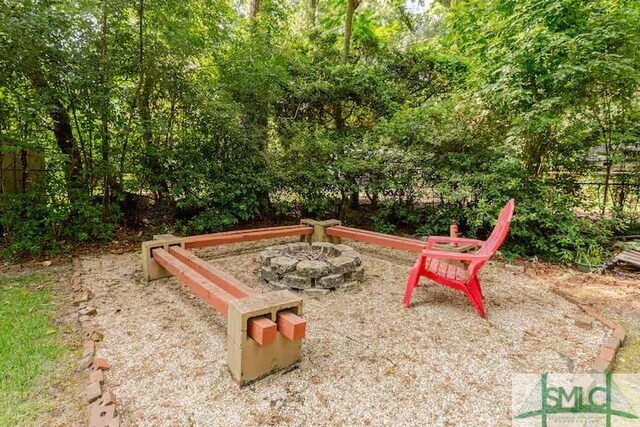 view of jungle gym with an outdoor fire pit