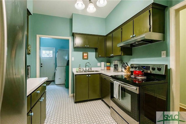 kitchen featuring light countertops, under cabinet range hood, a sink, and stainless steel appliances