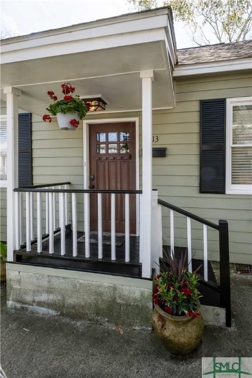 doorway to property featuring covered porch