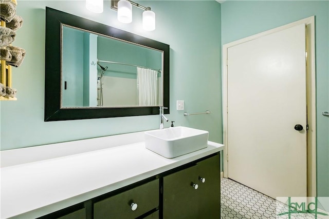 full bath featuring tile patterned floors, vanity, and a shower with curtain