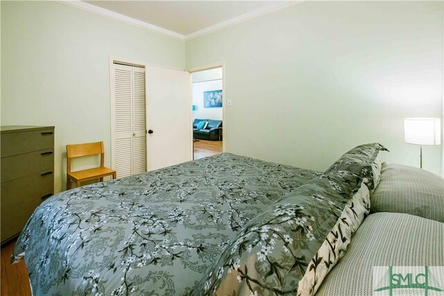 bedroom featuring a closet and crown molding