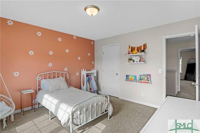 218 Herty Ln, Hinesville, GA 31313 - carpeted bedroom with baseboards and an accent wall