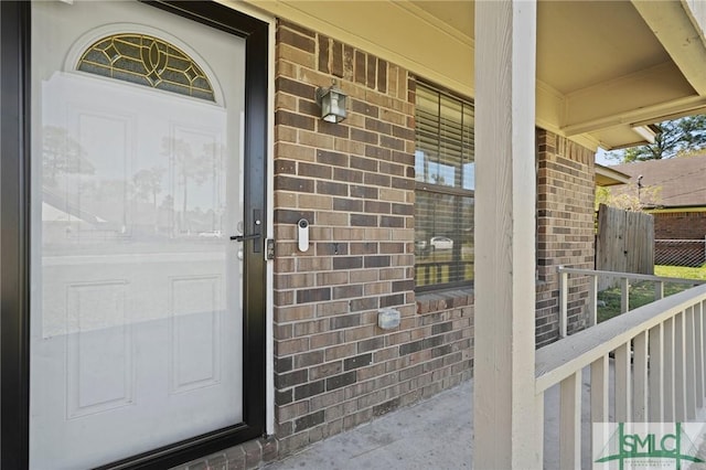 726 Timber Ridge Trl, Hinesville, GA 31313 - doorway to property with covered porch and brick siding