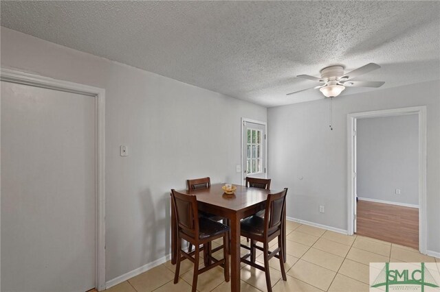 726 Timber Ridge Trl, Hinesville, GA 31313 - dining space with baseboards, a textured ceiling, light tile patterned floors, and a ceiling fan