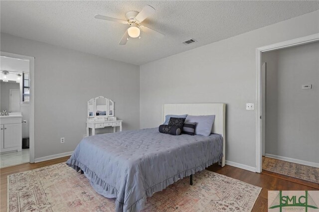 726 Timber Ridge Trl, Hinesville, GA 31313 - bedroom with wood finished floors, a textured ceiling, baseboards, and visible vents
