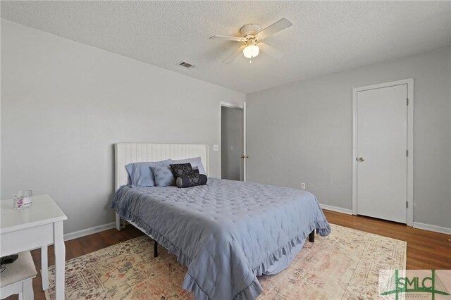 726 Timber Ridge Trl, Hinesville, GA 31313 - bedroom featuring wood finished floors, a textured ceiling, baseboards, and visible vents