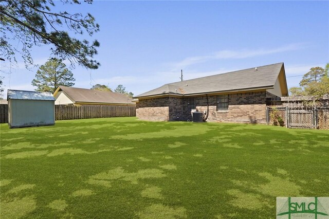 726 Timber Ridge Trl, Hinesville, GA 31313 - view of yard with a fenced backyard, an outbuilding, central air condition unit, and a storage shed