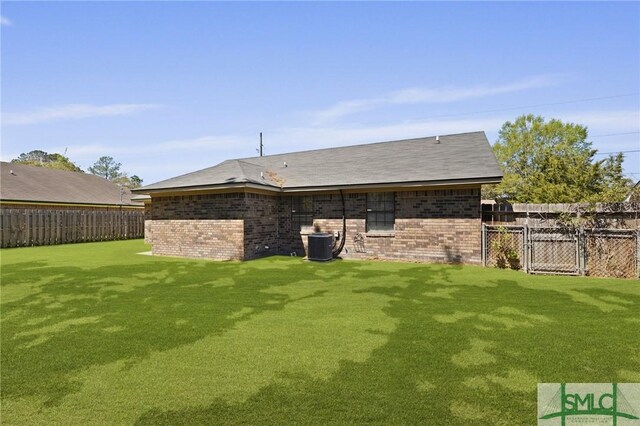 726 Timber Ridge Trl, Hinesville, GA 31313 - back of property featuring a lawn, brick siding, a fenced backyard, and cooling unit