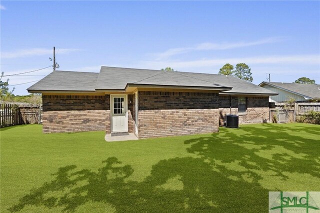 726 Timber Ridge Trl, Hinesville, GA 31313 - rear view of house featuring brick siding, central AC unit, and a yard