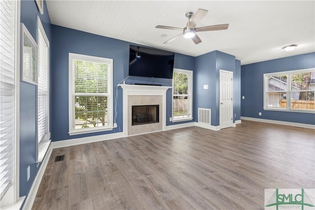 90 Cottage Ct, Richmond Hill, GA 31324 - unfurnished living room with baseboards, ceiling fan, visible vents, and wood finished floors