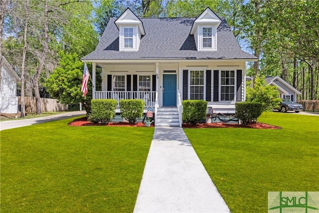 90 Cottage Ct, Richmond Hill, GA 31324 - cape cod home with covered porch, a front yard, a shingled roof, and fence