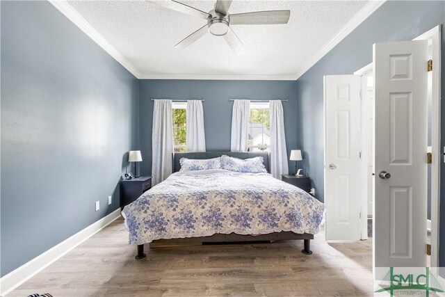 90 Cottage Ct, Richmond Hill, GA 31324 - bedroom featuring a textured ceiling, light wood-style flooring, and crown molding