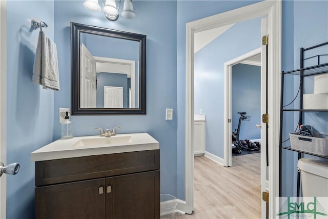 90 Cottage Ct, Richmond Hill, GA 31324 - half bathroom with vanity, baseboards, and wood finished floors