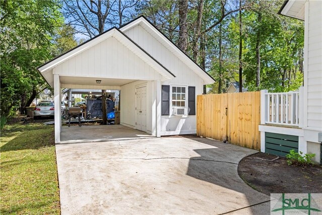 90 Cottage Ct, Richmond Hill, GA 31324 - garage with driveway, cooling unit, and fence