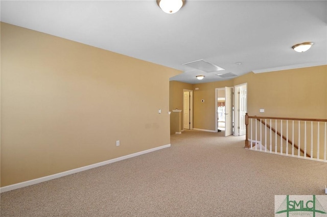 spare room featuring baseboards and carpet