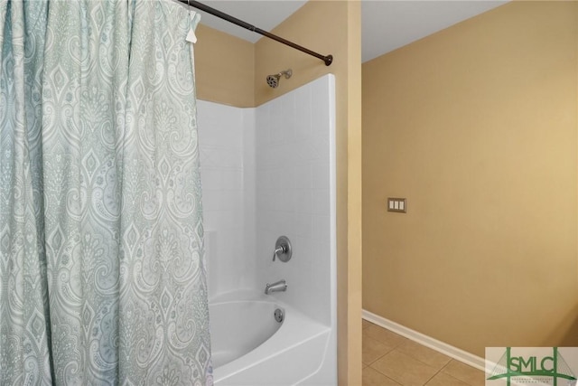 bathroom featuring baseboards, shower / bath combination with curtain, and tile patterned floors