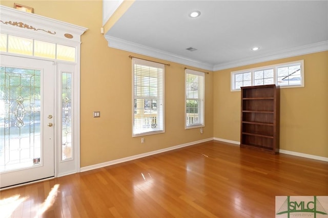foyer entrance with baseboards, wood finished floors, recessed lighting, and crown molding