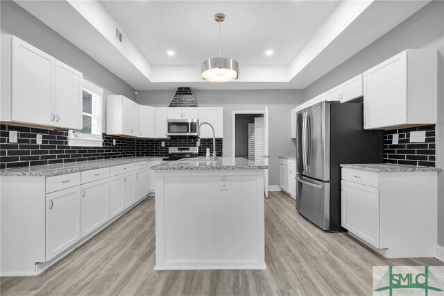 11141/2 E Bolton St, Savannah, GA 31404 - kitchen featuring white cabinetry, stainless steel appliances, a tray ceiling, and visible vents