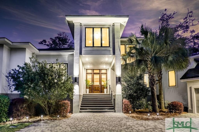 28 Delegal Rd, Savannah, GA 31411 - exterior entry at dusk with stucco siding