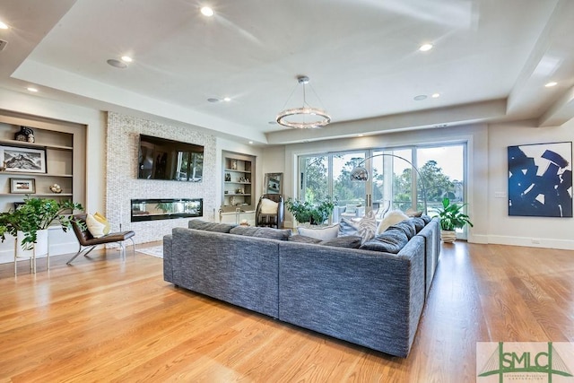 28 Delegal Rd, Savannah, GA 31411 - living area featuring built in features, a tray ceiling, and wood finished floors