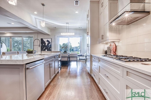 28 Delegal Rd, Savannah, GA 31411 - kitchen featuring a healthy amount of sunlight, visible vents, light wood-style flooring, appliances with stainless steel finishes, and wall chimney exhaust hood