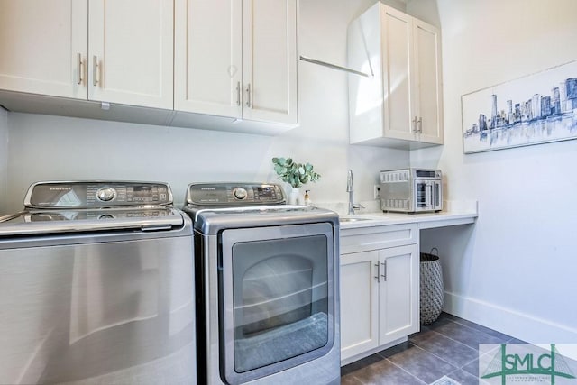 28 Delegal Rd, Savannah, GA 31411 - laundry room with a sink, dark tile patterned floors, baseboards, independent washer and dryer, and cabinet space