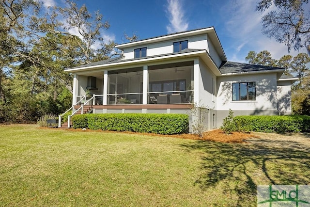 28 Delegal Rd, Savannah, GA 31411 - rear view of house with a lawn, a sunroom, stairs, and stucco siding