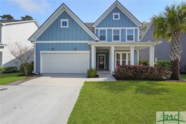 craftsman inspired home featuring board and batten siding, an attached garage, driveway, and a front lawn