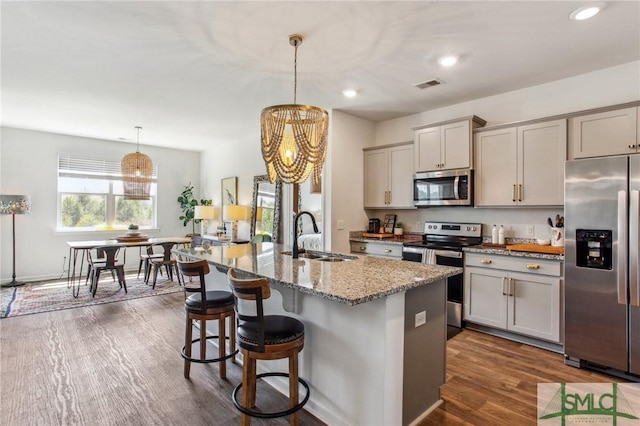 111 Troupe Dr, Savannah, GA 31407 - kitchen featuring appliances with stainless steel finishes, gray cabinetry, light stone counters, a breakfast bar area, and recessed lighting