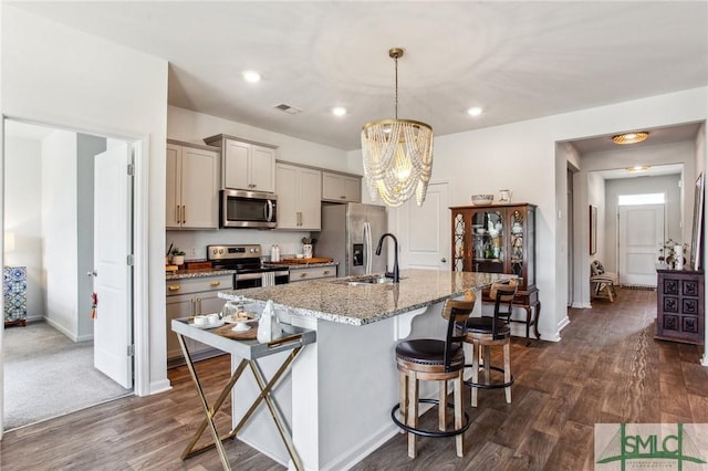111 Troupe Dr, Savannah, GA 31407 - kitchen with appliances with stainless steel finishes, gray cabinets, a kitchen breakfast bar, dark wood-type flooring, and recessed lighting