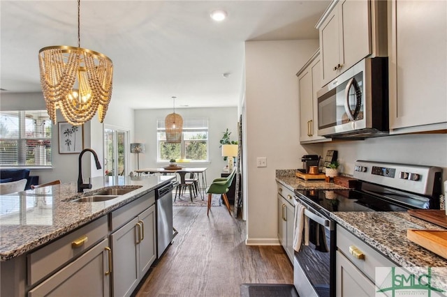 111 Troupe Dr, Savannah, GA 31407 - kitchen with stainless steel appliances, gray cabinets, a chandelier, and dark wood-type flooring