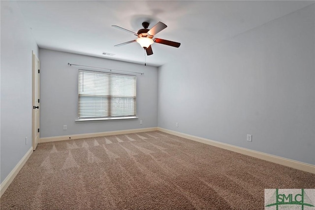unfurnished room featuring baseboards, ceiling fan, visible vents, and light colored carpet