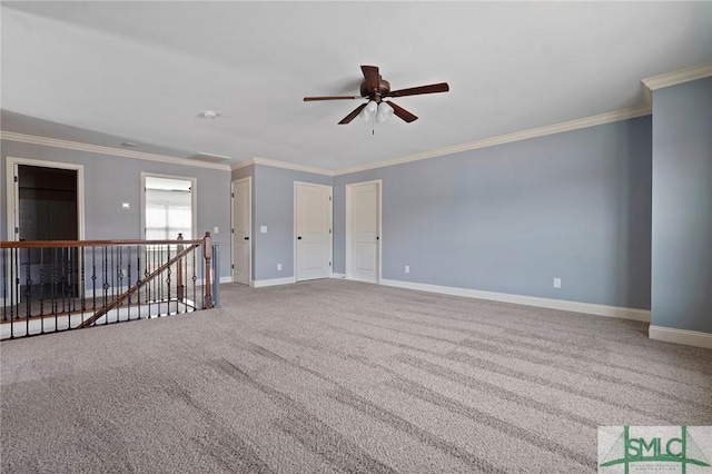 unfurnished room with a ceiling fan, ornamental molding, carpet, and baseboards