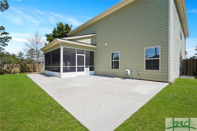 back of house with a sunroom, fence, a yard, and a patio area