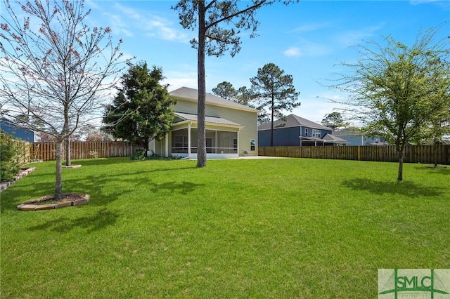view of yard featuring a fenced backyard and a sunroom