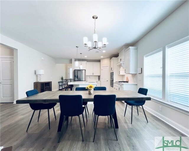 125 Long Creek Ln, Richmond Hill, GA 31324 - dining room with a chandelier, wood finished floors, recessed lighting, and baseboards