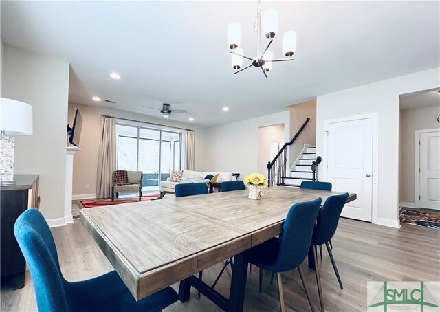125 Long Creek Ln, Richmond Hill, GA 31324 - dining area featuring stairway, light wood finished floors, a chandelier, baseboards, and recessed lighting
