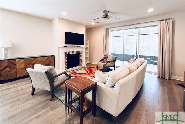 125 Long Creek Ln, Richmond Hill, GA 31324 - living area with light wood-style flooring, a ceiling fan, a fireplace, recessed lighting, and baseboards