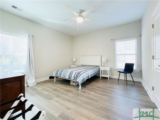 125 Long Creek Ln, Richmond Hill, GA 31324 - bedroom with light wood finished floors, ceiling fan, and baseboards