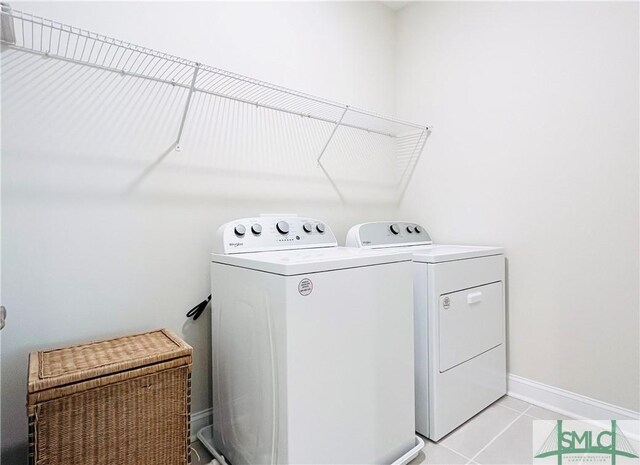 125 Long Creek Ln, Richmond Hill, GA 31324 - laundry area featuring washing machine and clothes dryer, light tile patterned flooring, and baseboards
