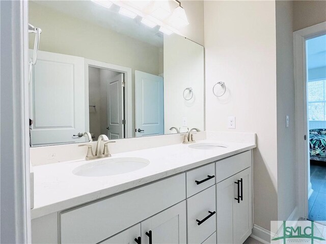 125 Long Creek Ln, Richmond Hill, GA 31324 - ensuite bathroom featuring double vanity and baseboards
