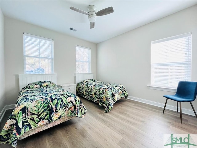 125 Long Creek Ln, Richmond Hill, GA 31324 - bedroom featuring wood finished floors, a ceiling fan, and baseboards