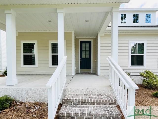 125 Long Creek Ln, Richmond Hill, GA 31324 - doorway to property with a porch