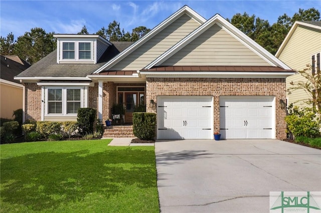 view of front of house featuring a standing seam roof, an attached garage, driveway, a front yard, and brick siding