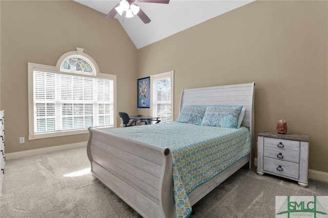 carpeted bedroom featuring multiple windows, high vaulted ceiling, baseboards, and a ceiling fan